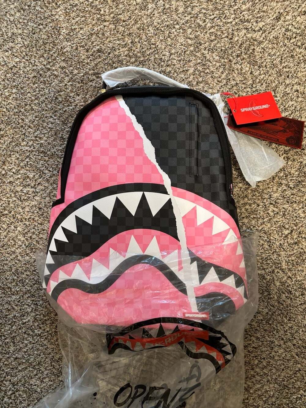 Sprayground Pink and Black Tear Sip Savage Backpack. Full size